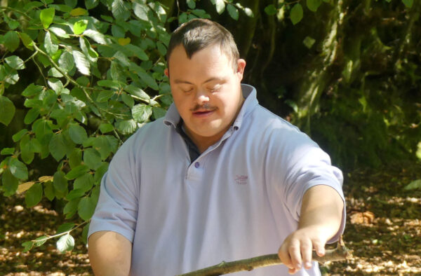 Man with stick in woods