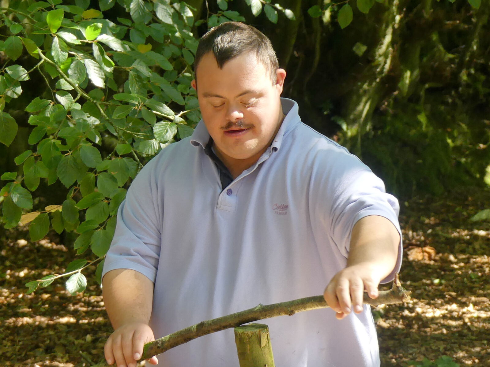 Man with stick in woods
