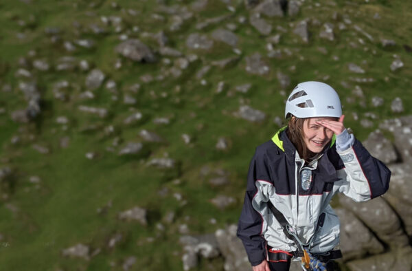 photograph looking down at a young female climbing a rock face