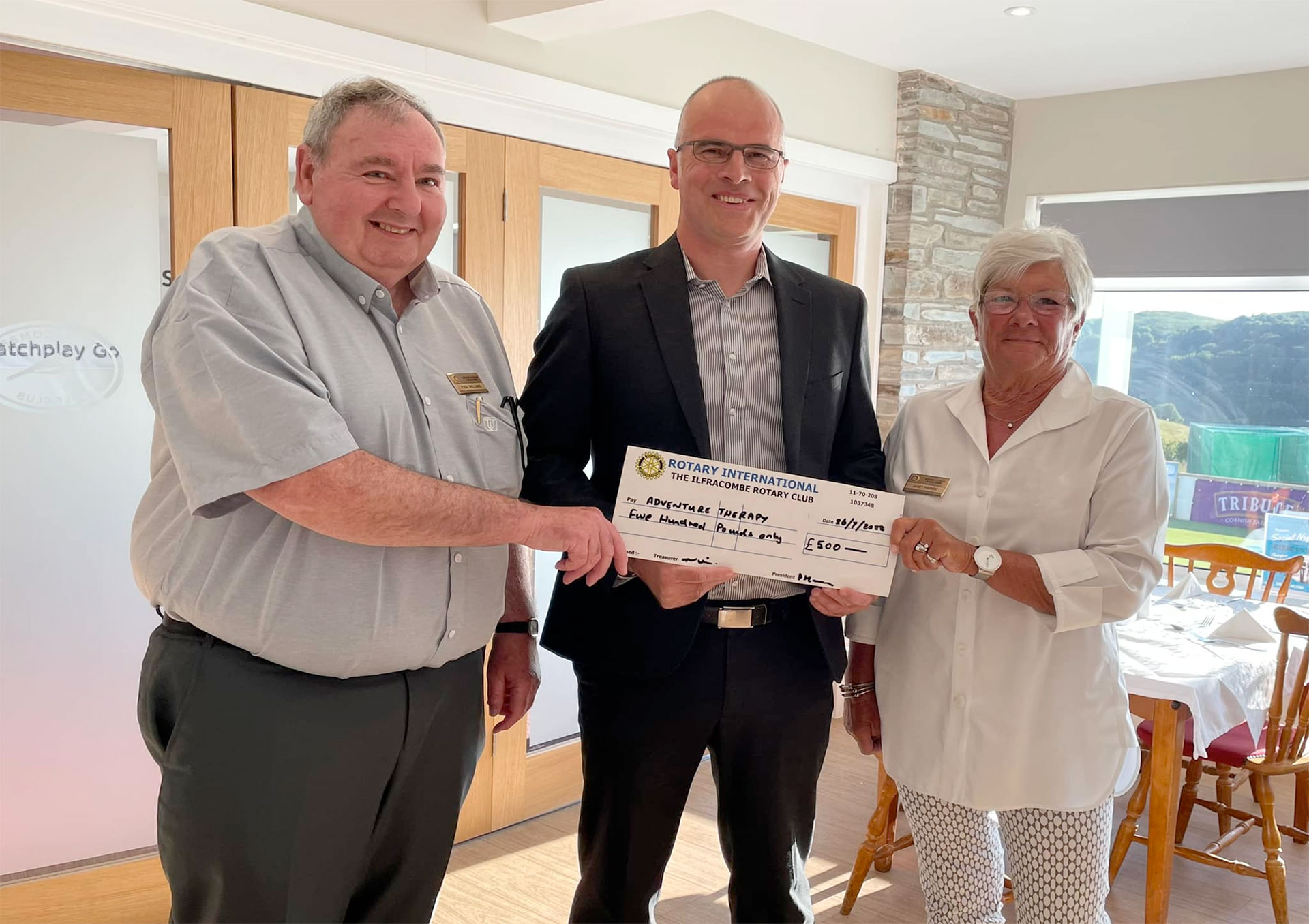 Rob Emery receiving cheque from Ilfracombe Rotary Club